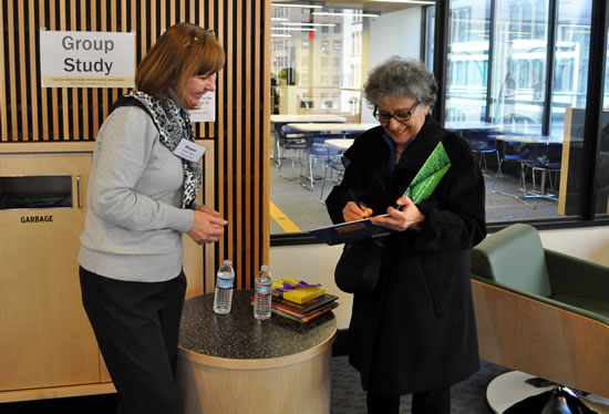 Arlene Alda signing copy of her book