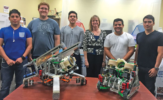 President Sharon DeVivo with students in technology department