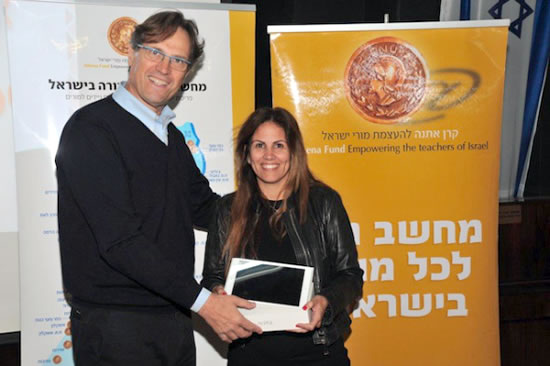 Uri Ben-Ari, founder and president of Athena Fund, gives an iPad to special education techer